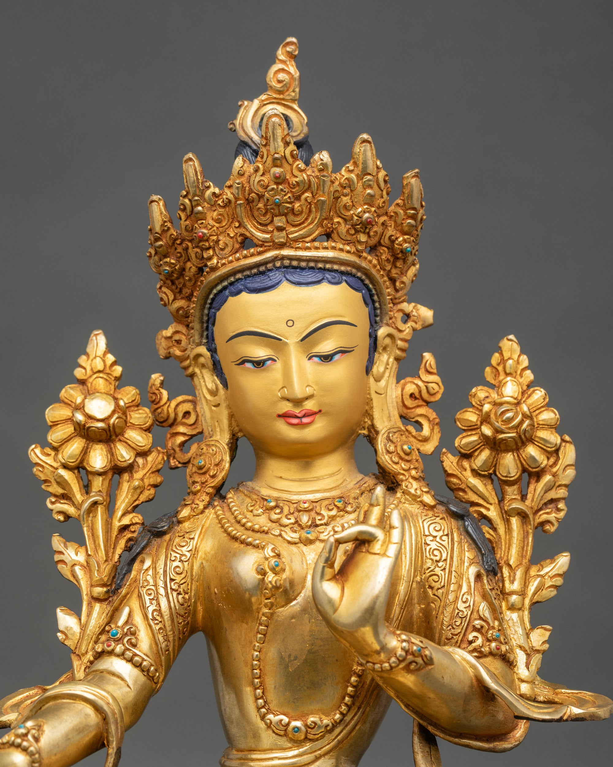 Close-up of Green Tara Drolma statue, hand-painted gold face and lotus pedestal