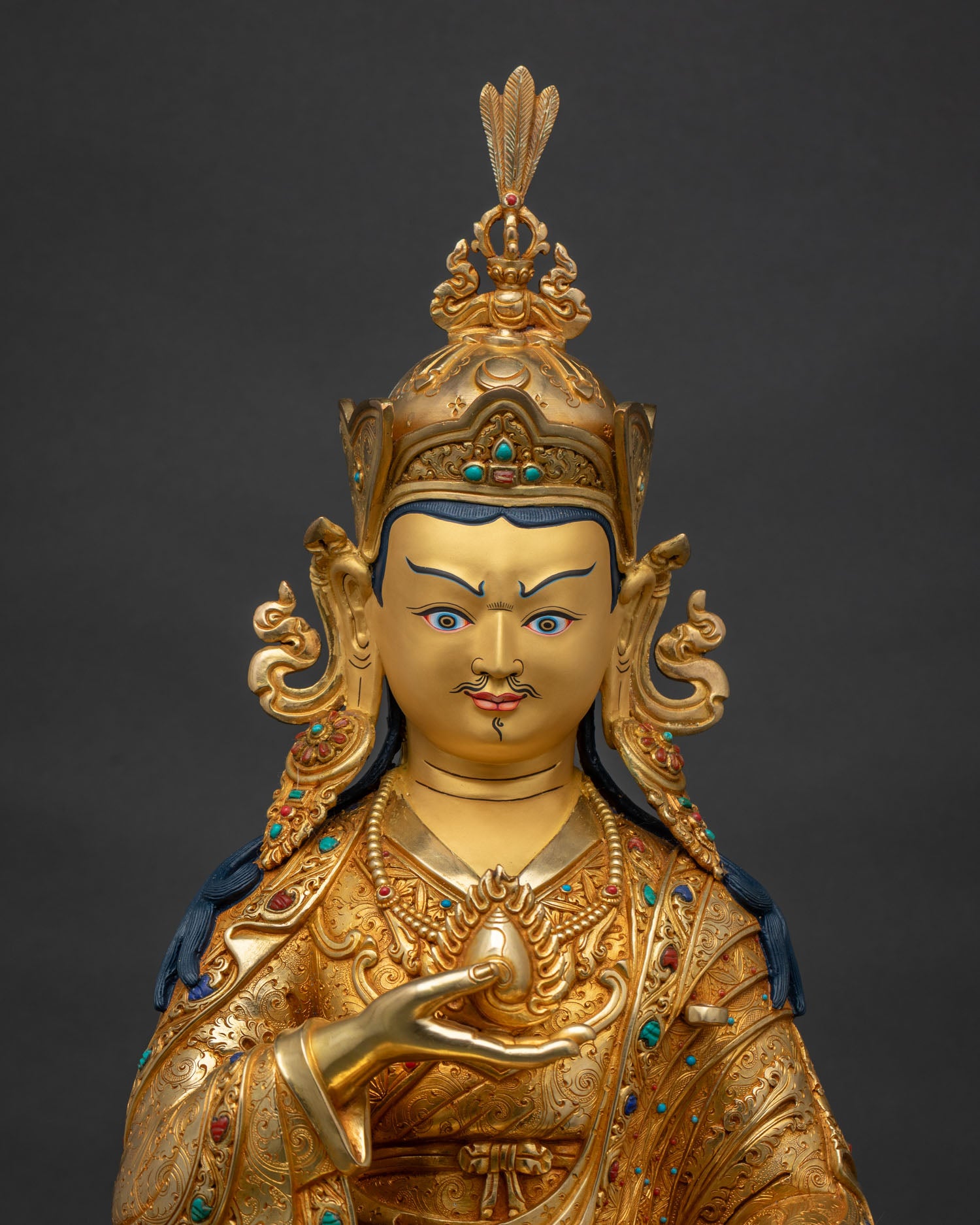 Close-up of Guru Norlha statue, gold fire-gilded kasaya robes with inlaid semi-precious stones