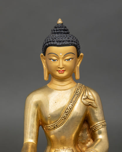 Close-up of Shakyamuni Buddha statue showing detailed craftsmanship on robes and lotus