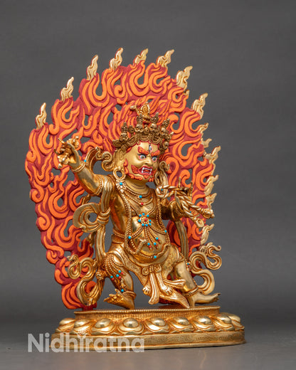 Close-up of Vajrapani statue showing intricate gold fire-gilded details and halo colors