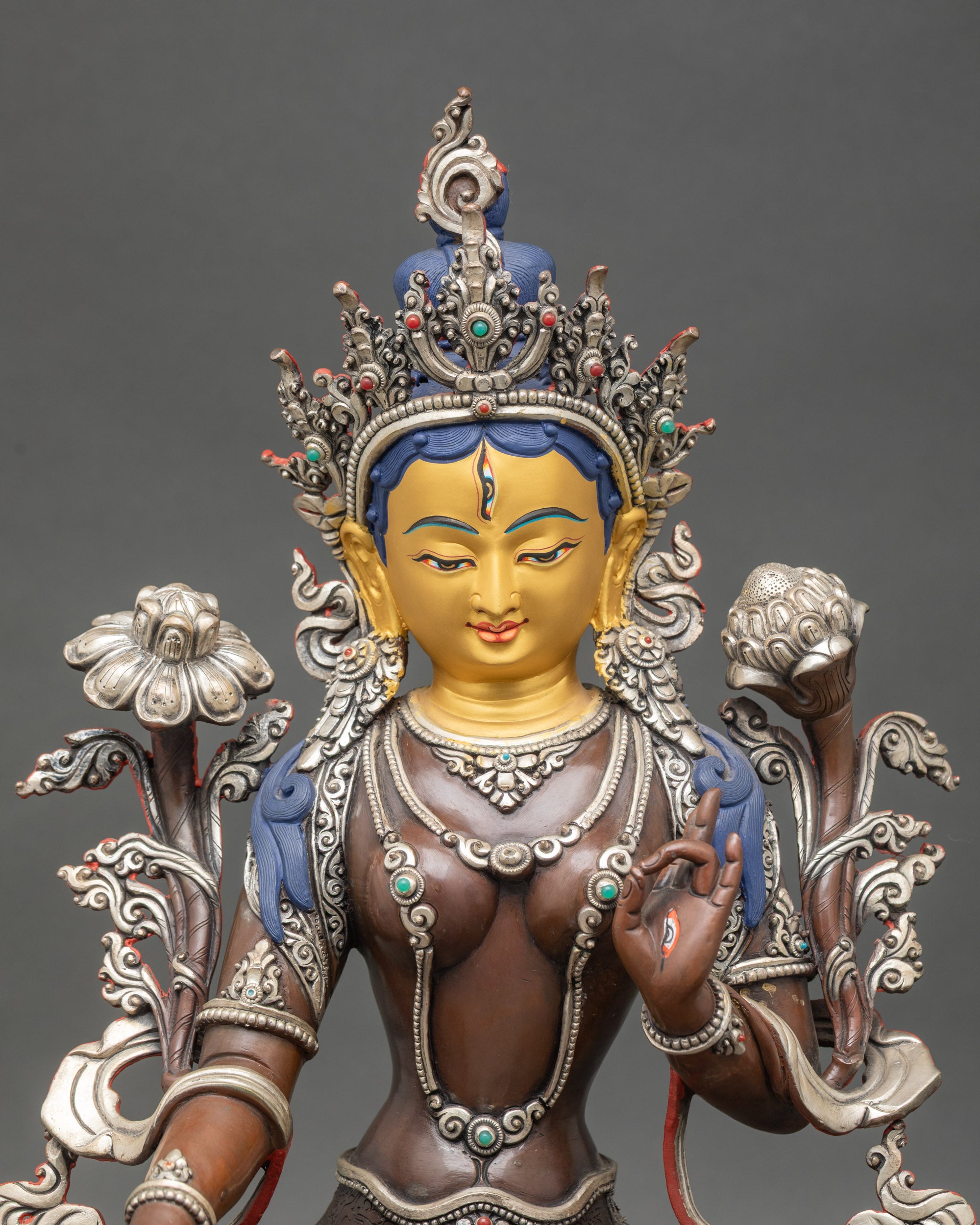 Close up of White Tara Bodhisattva seven eyes detail Nepalese lost wax copper statue
