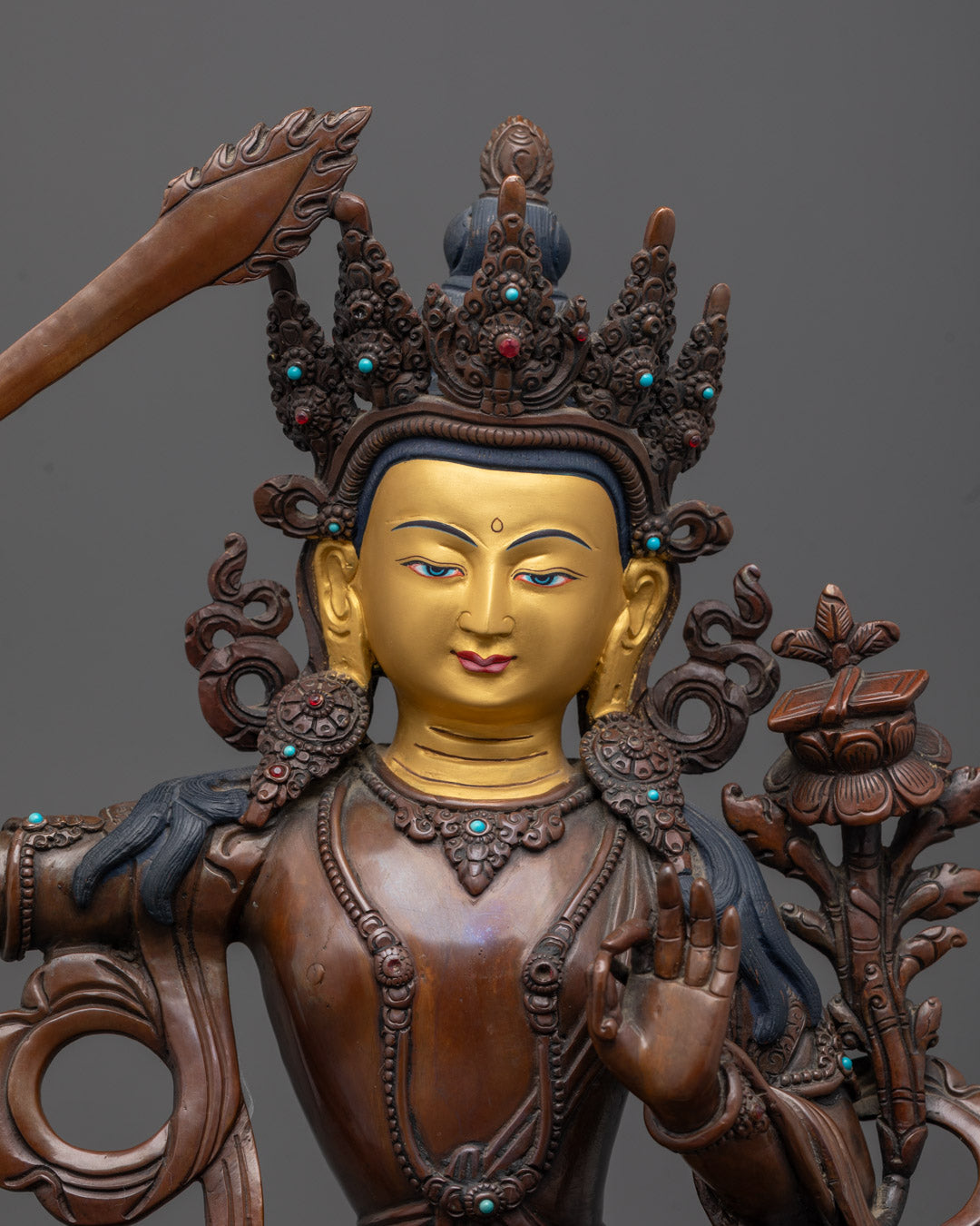 Close-up 24k Gold Gilded Face Manjushri Bodhisattva Statue in Oxidized Copper Finish