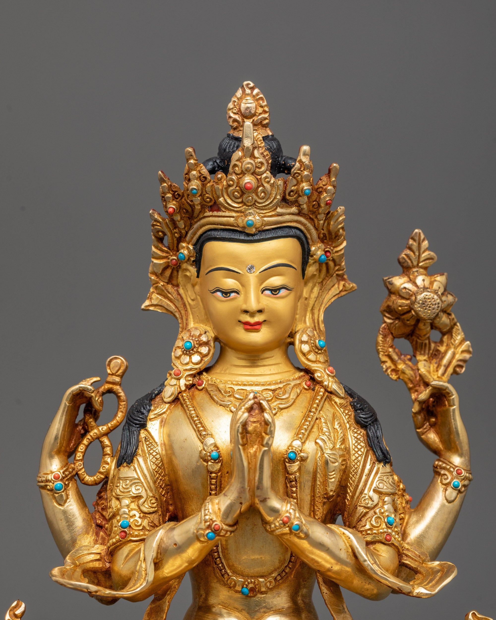 Close-up Chenrezig Avalokiteshvara statue showing wish-fulfilling gem and utpala flower
