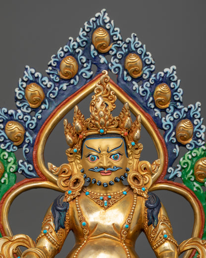Close-up Dzambhala wrathful face, gold fire-gilded Buddhist prosperity statue