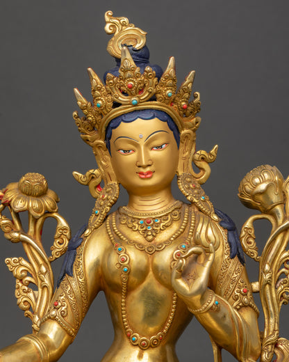 Close-up Green Tara face gold-painted finish, jeweled crown, compassionate expressionv