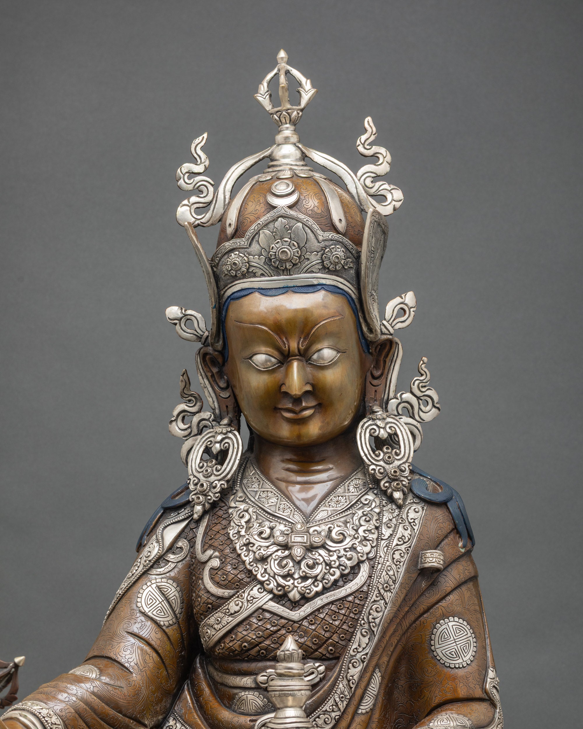 Close-up Padmasambhava statue, oxidized dark finish, silver-plated ornaments, Nepali Buddhist art