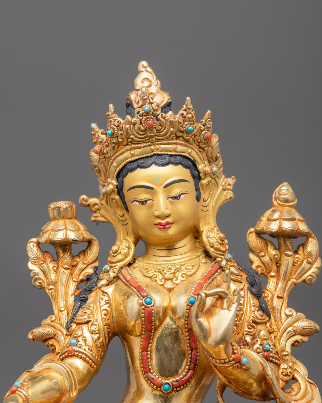 Close-up angle of Green Tara’s intricate crown and semi-precious stones
