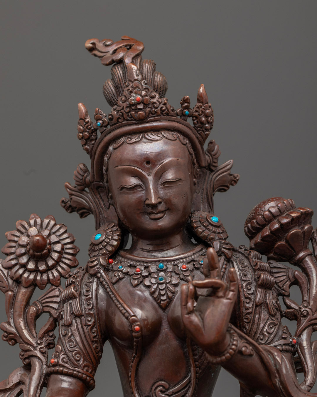 Close-up angle of White Tara's face highlighting third eye and antique oxidized finish details