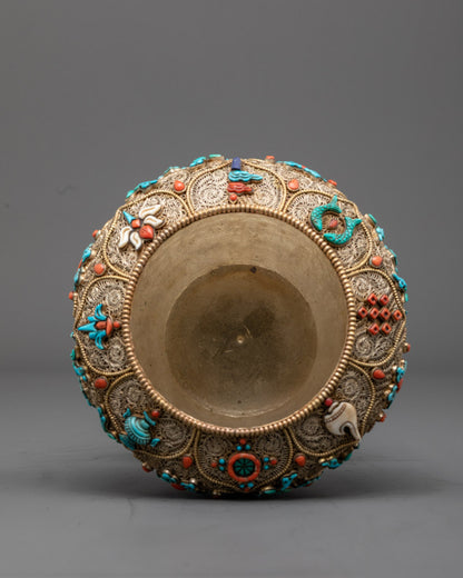 Close-up angled view of sacred Nepali rice bowl's gold filigree