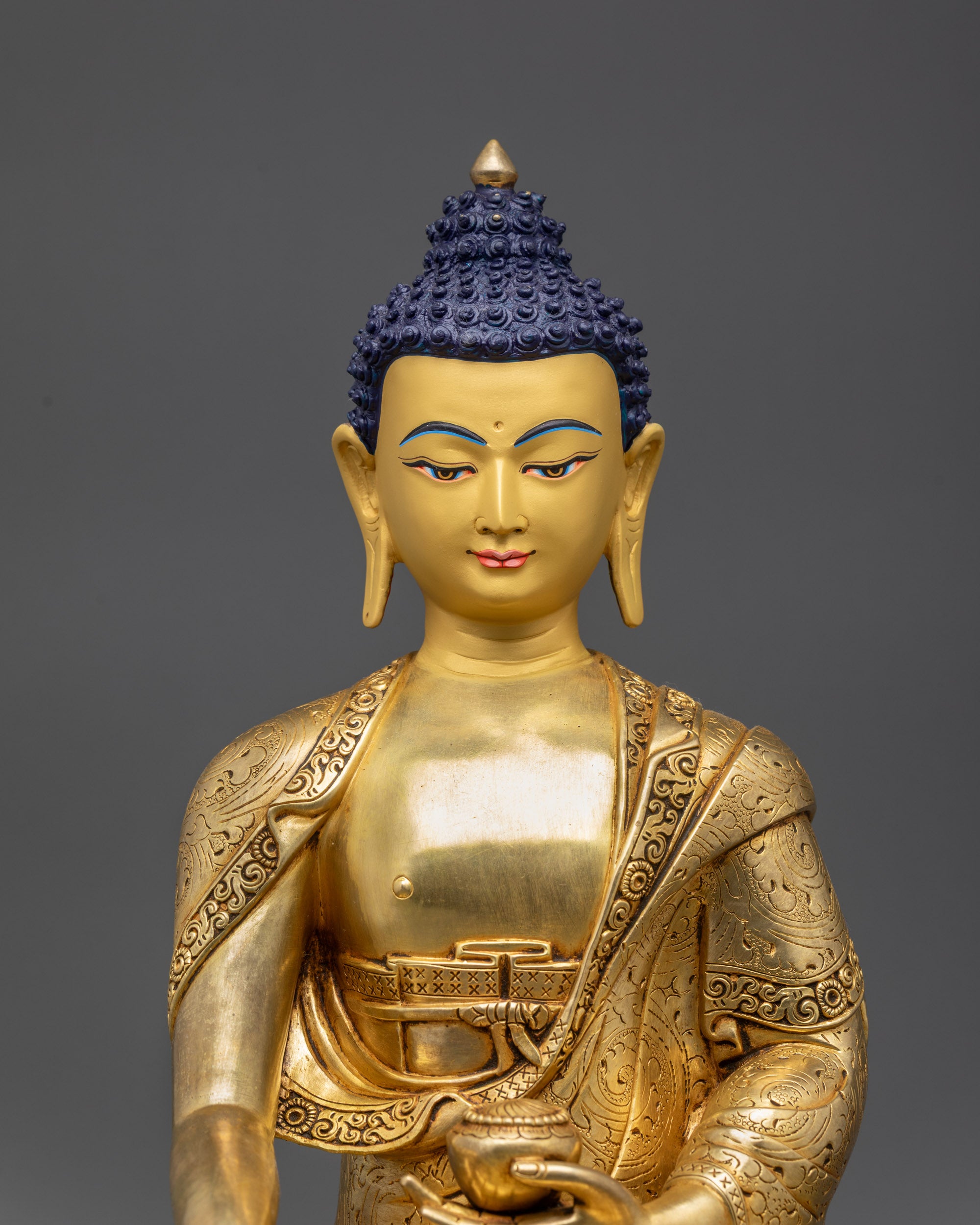 Close-up intricate robe patterns on copper Shakyamuni Buddha Sculpture Nepal