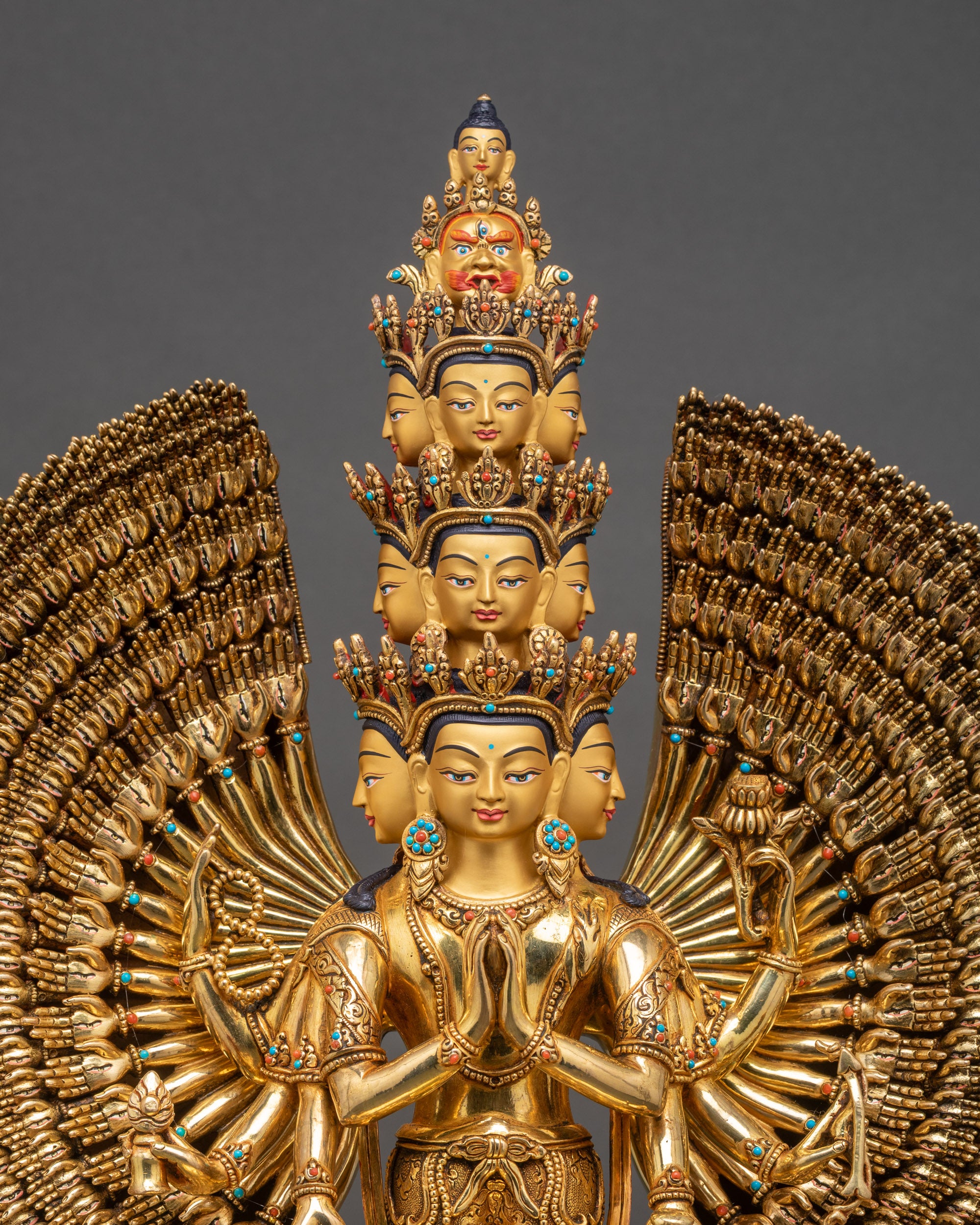 Close-up of 1000-Armed Chenrezig sculpture, showing detailed copper and gold craftsmanship, intricate arms, and multi-heads