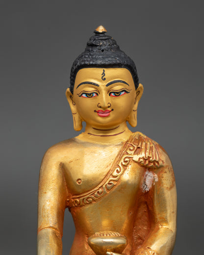 Close-up of 24K gold-painted face on Shakyamuni Buddha Nepal statue