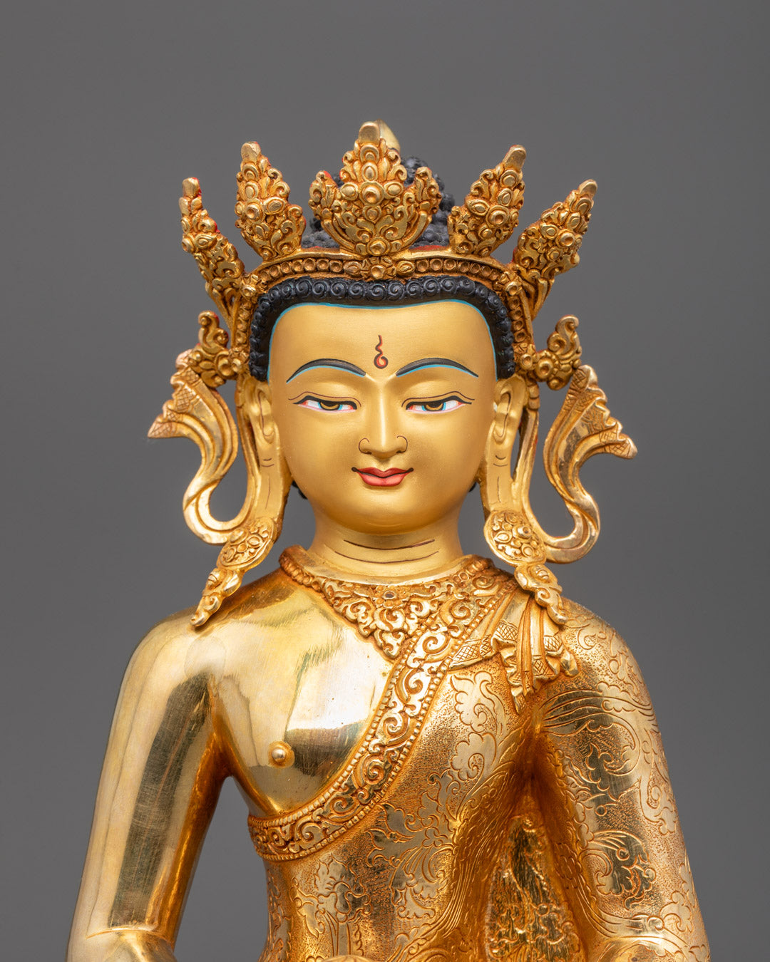 Close-up of Amida Buddha's gold-gilded face and monk’s bowl in Dhyana Mudra