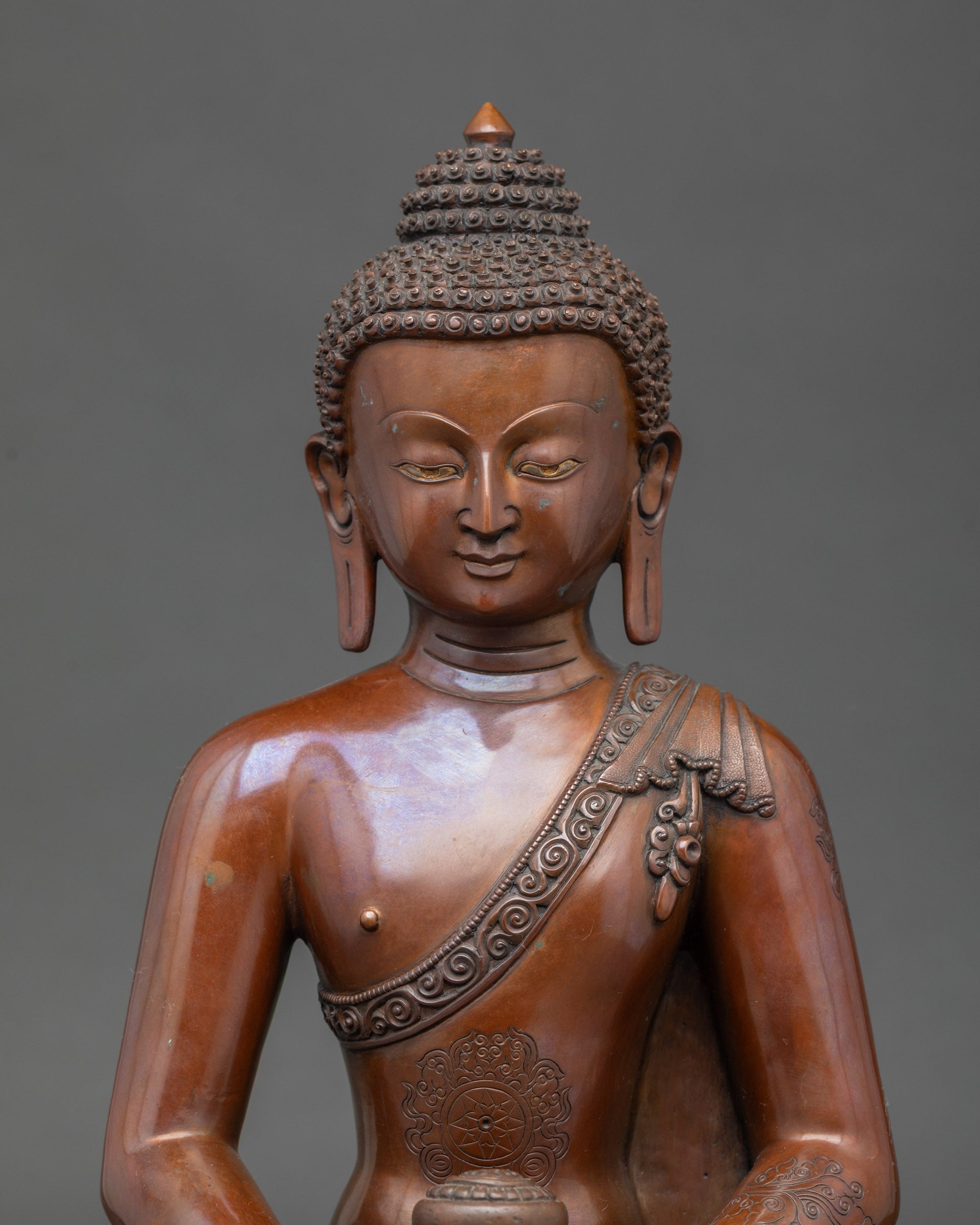 Close-up of Amitabha Buddha figurine showing intricate Newari artisan details