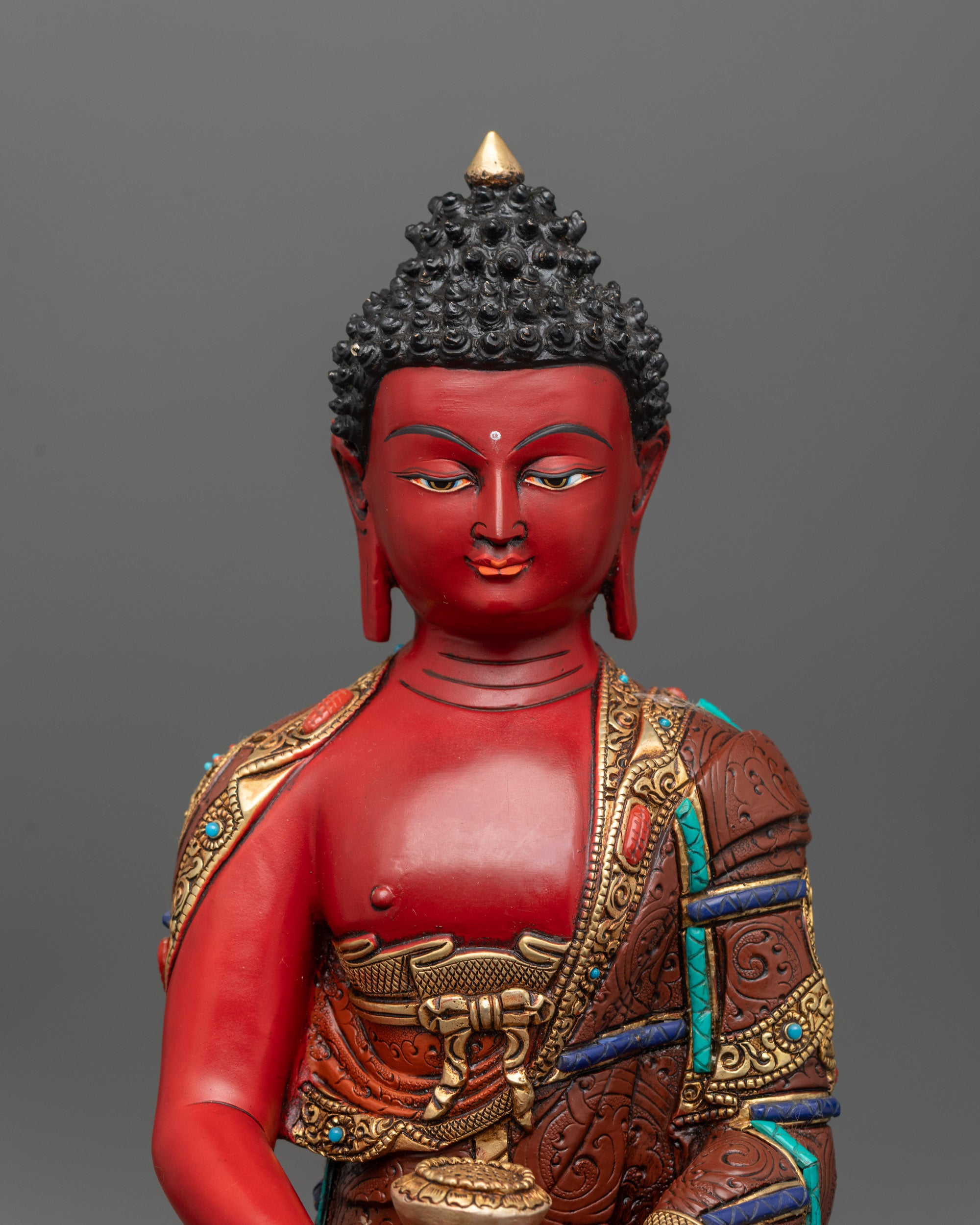 Close-up of Amitabha Buddha’s robe showing ashtamangala symbols and semi-precious stones