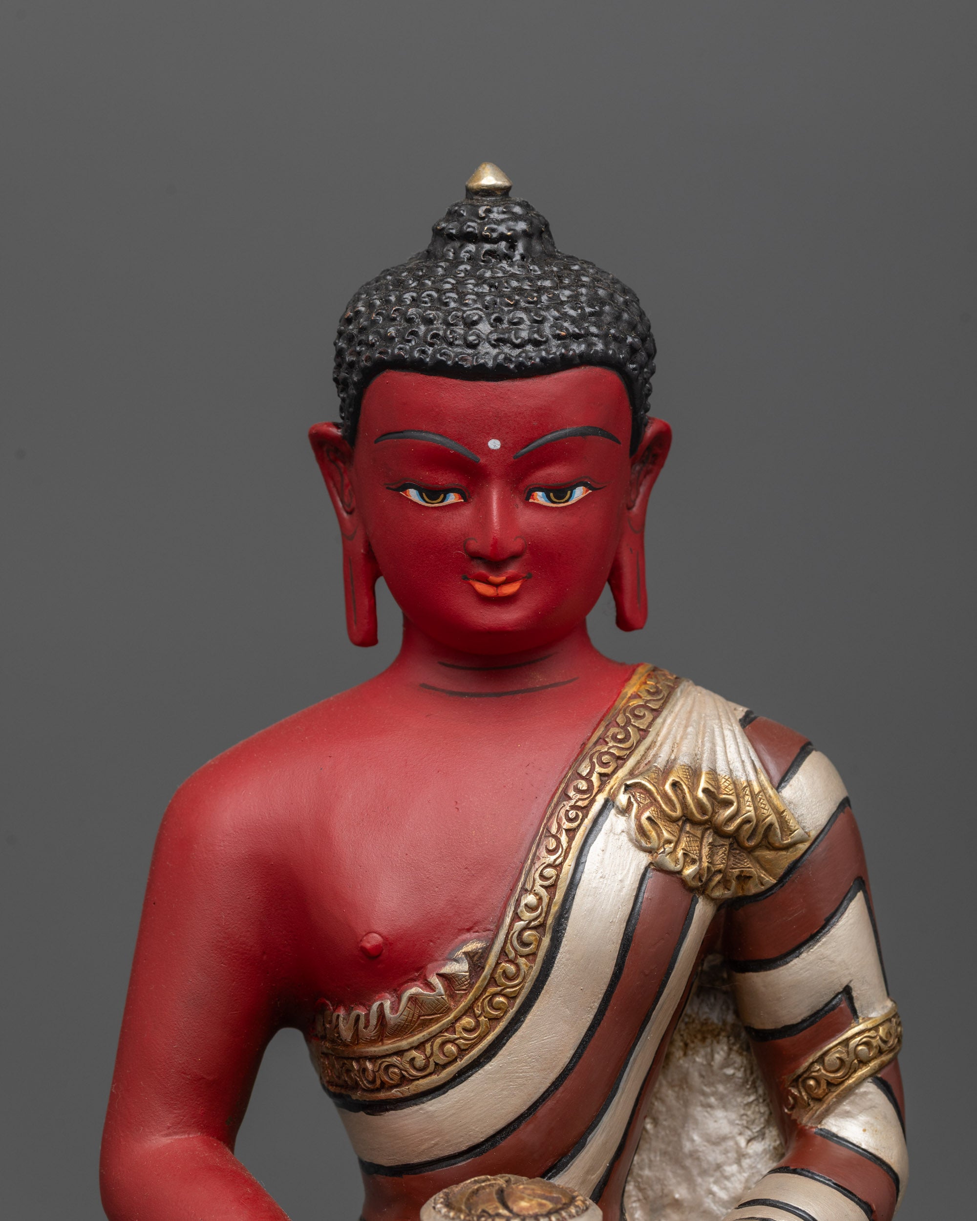 Close-up of Amitabha Buddha’s serene face with intricate acrylic color detailing