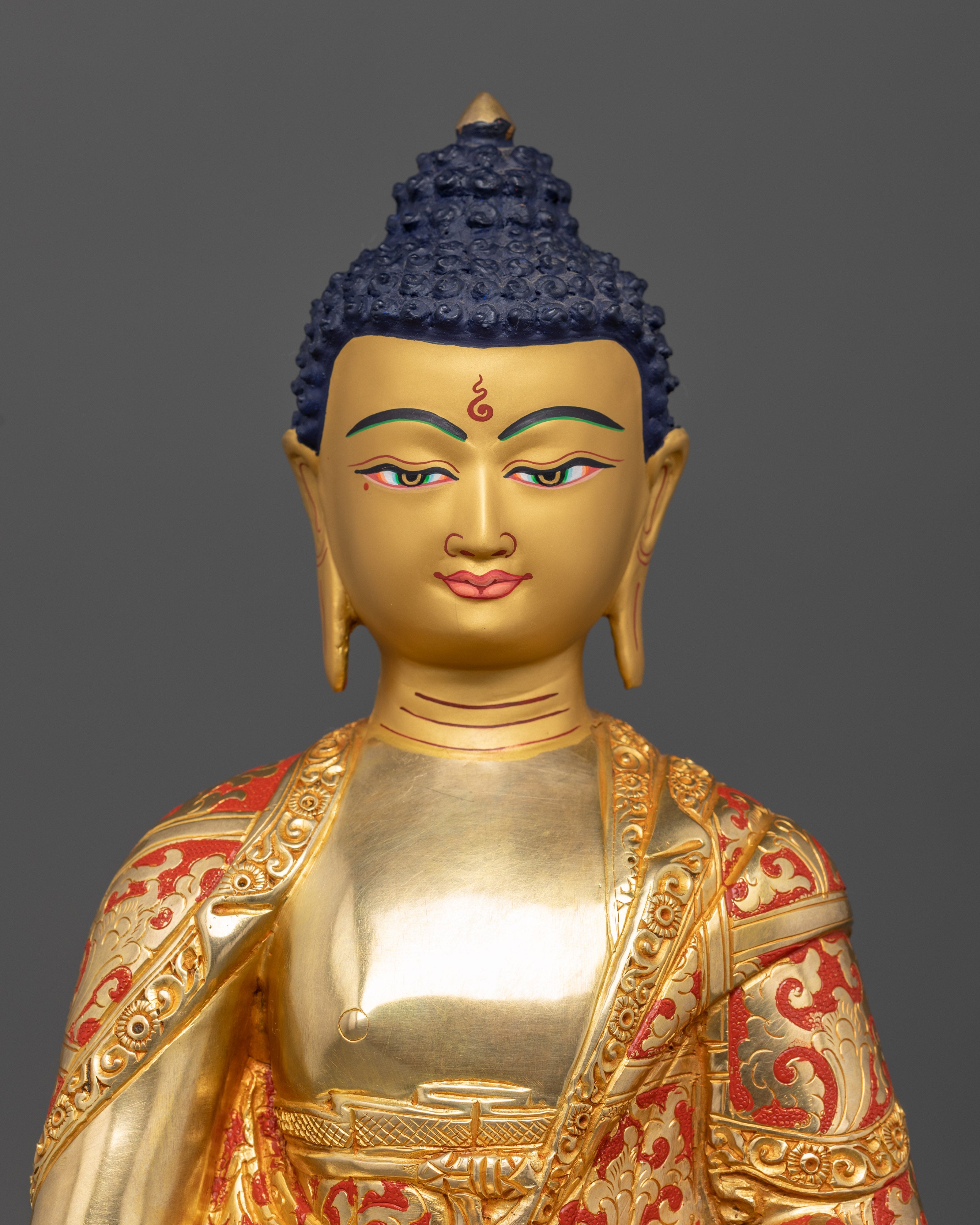 Close-up of Amitabha Buddha statue face, 24K gold-painted, Tibetan devotional sculpture
