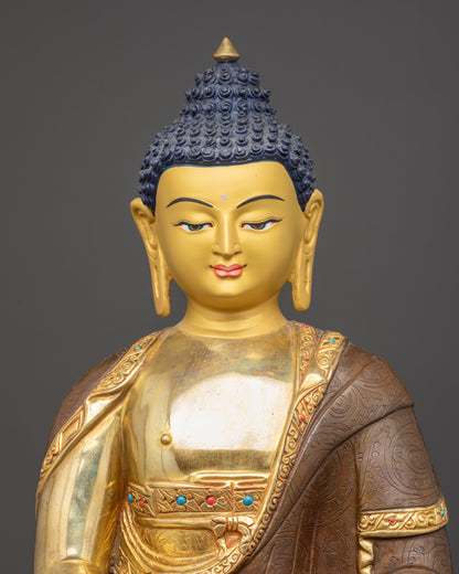 Close-up of Amitabha Buddha statue showing monk’s robe, sacred bowl, and gold fire-gilding