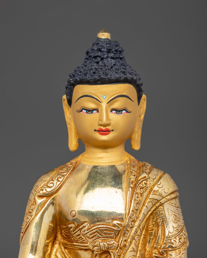 Close-up of Amitabha Buddha statue with 24K gold-painted face holding monk’s bowl