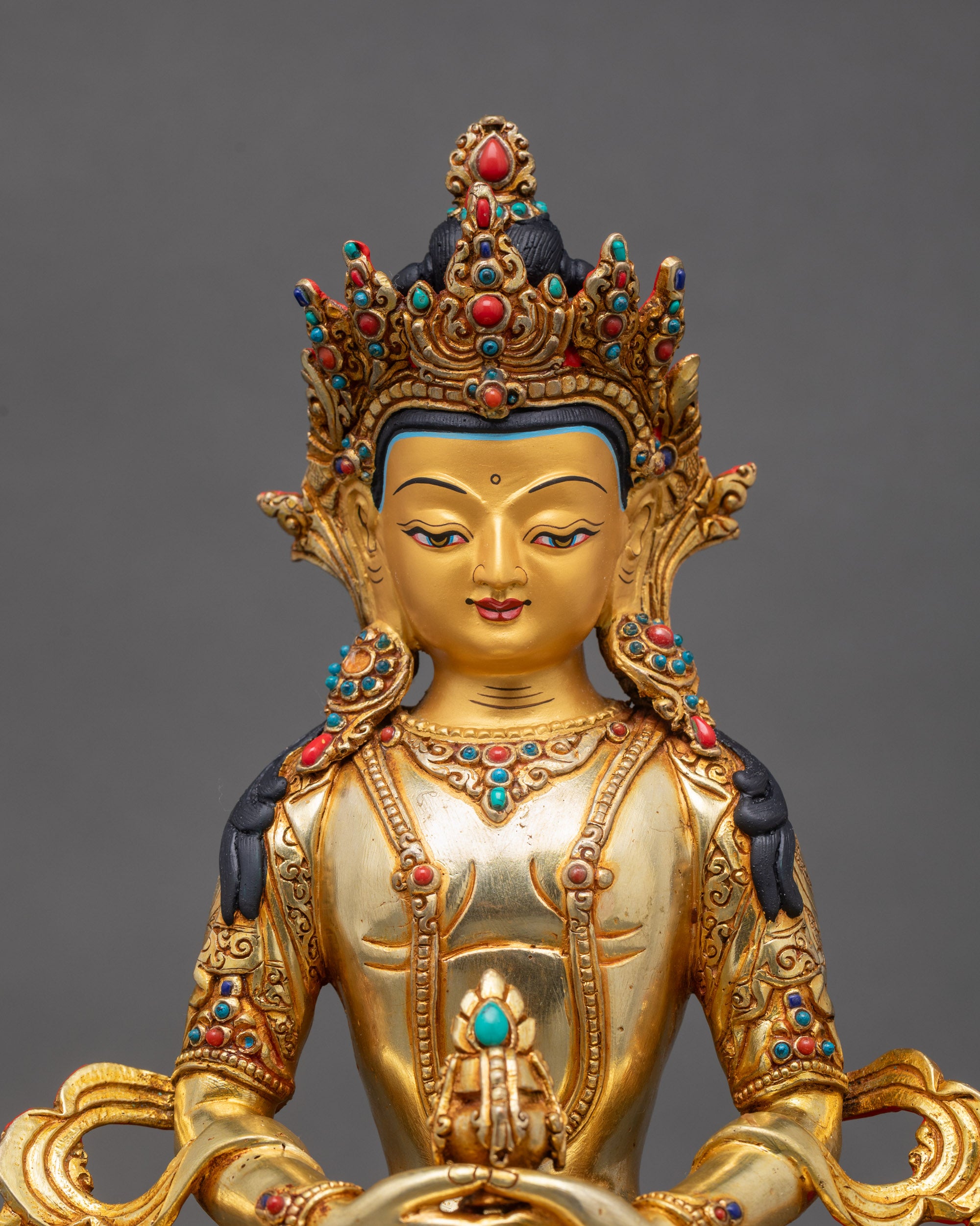 Close-up of Amitayus Buddha Statue showing lotus throne and long-life vase, copper and gold finish