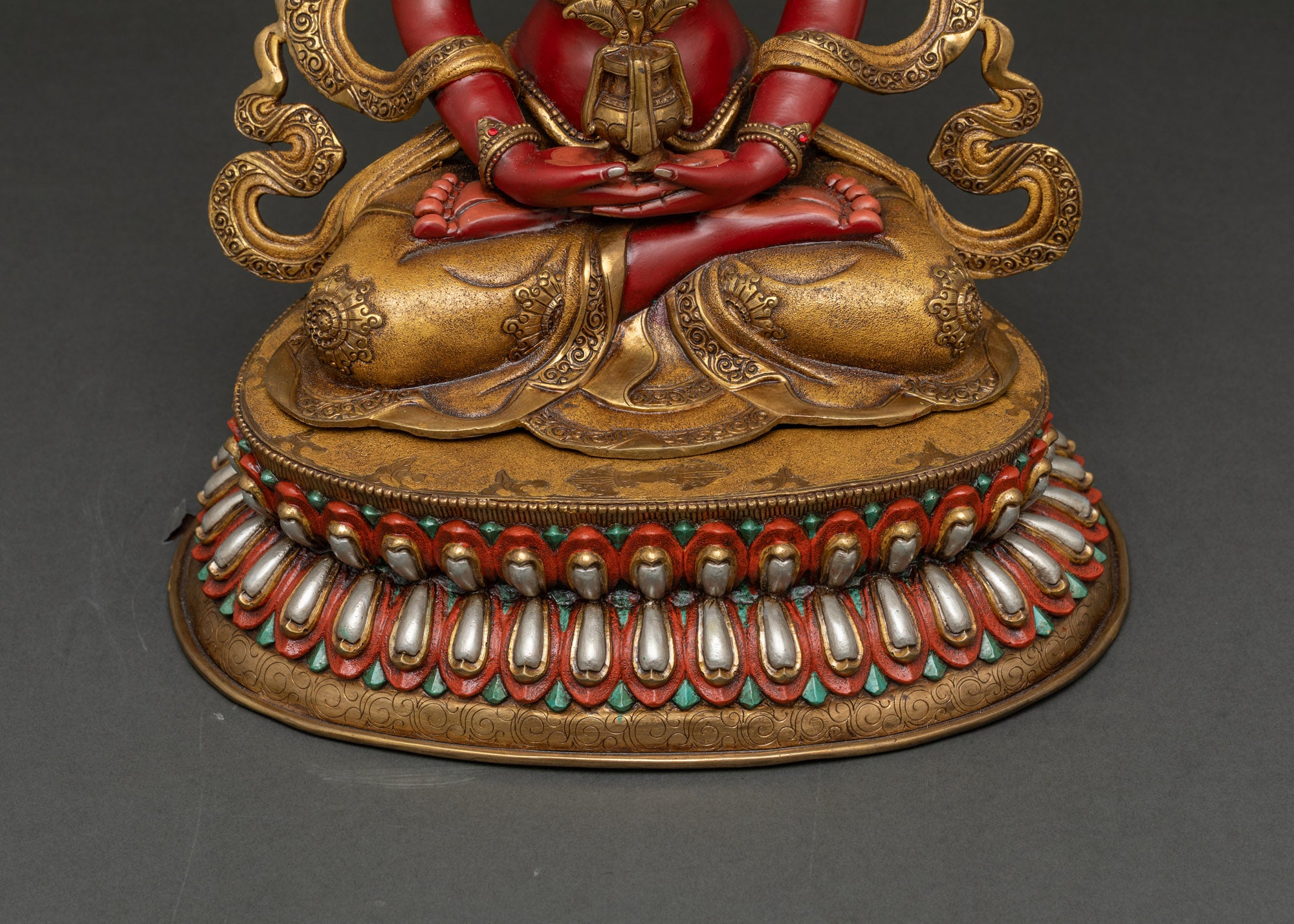 Close-up of Amitayus Buddha face painted with vibrant acrylic colors, serene expression