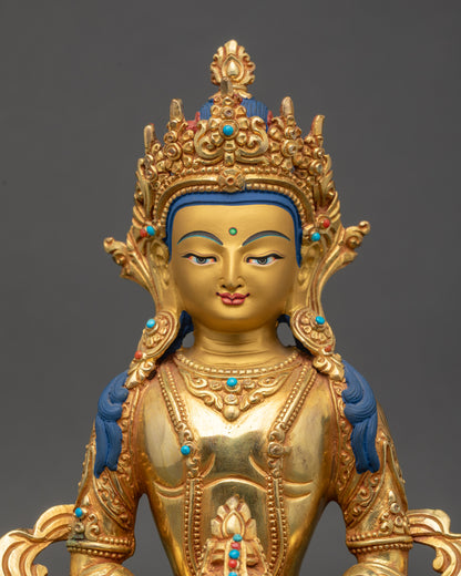 Close-up of Amitayus Buddha face with serene expression and 24K gold finish