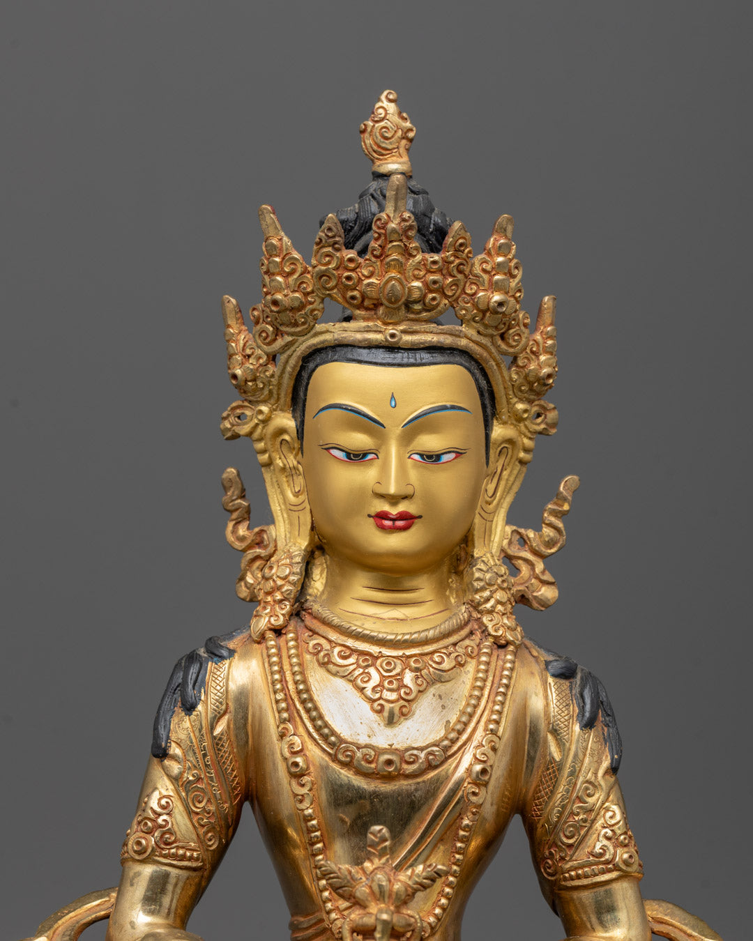 Close-up of Amitayus Tsepame Statue’s gold-gilded face showing detailed craftsmanship