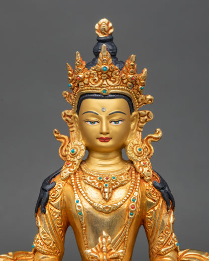 Close-up of Amitayus statue face showing serene expression and gold-painted details