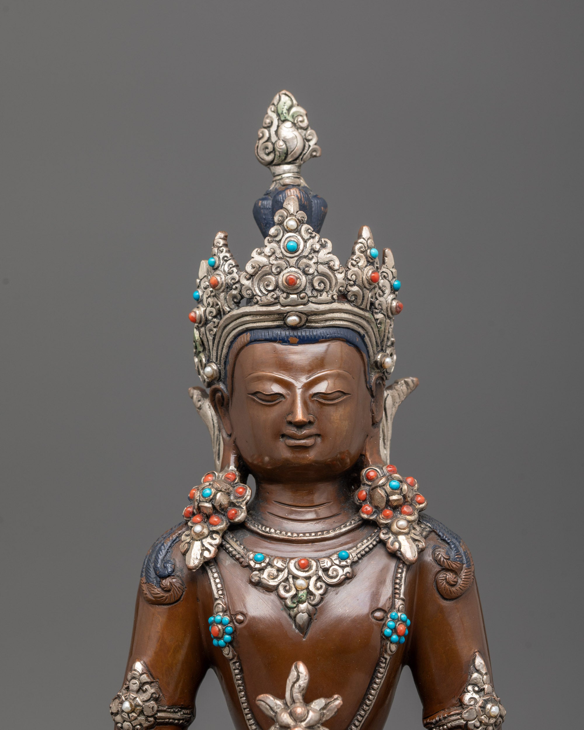 Close-up of Amitayus statue’s silver-plated crown and semi-precious stone details