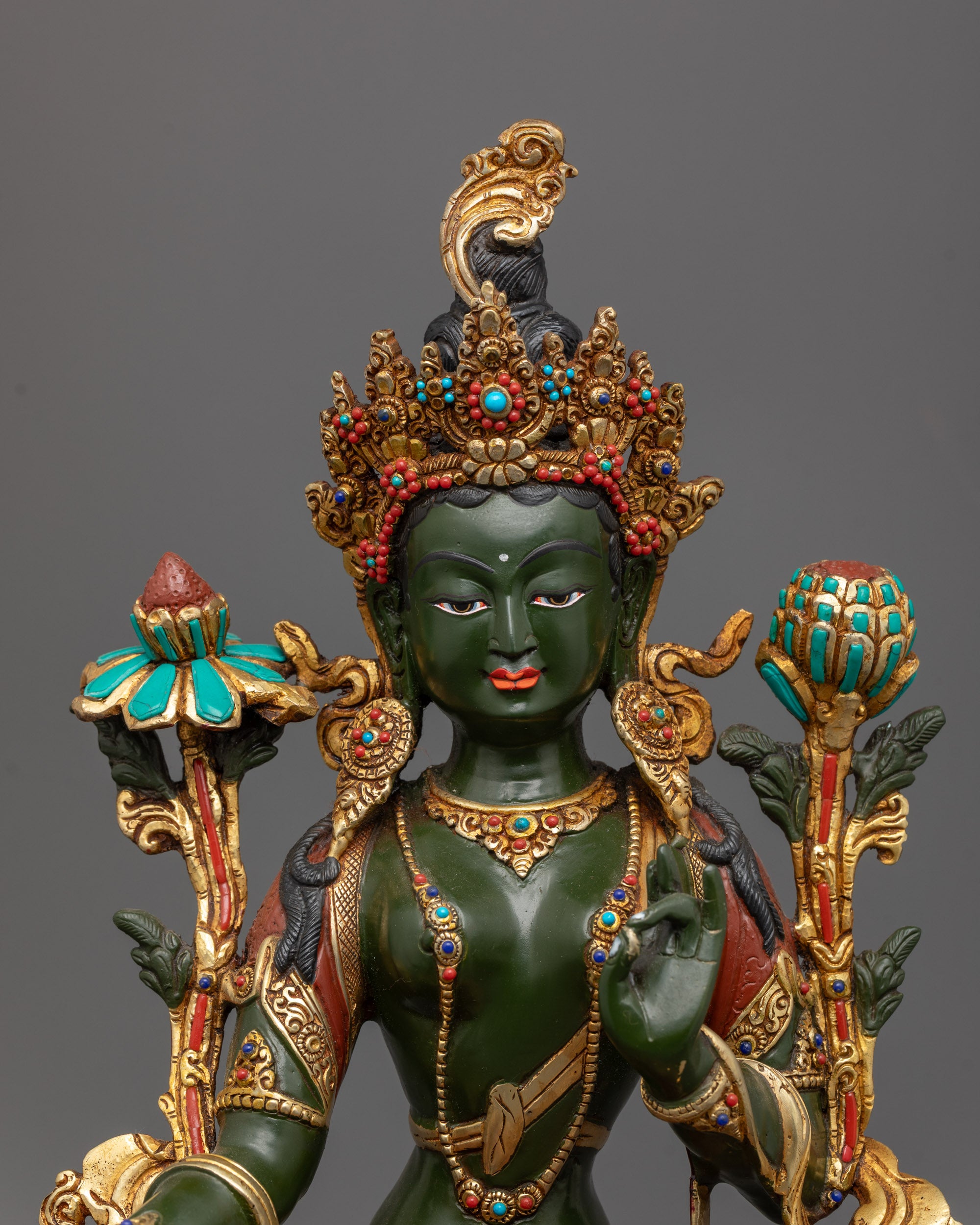 Close-up of Arya Tara Statue showing intricate carvings and utpala flower in Varada mudra