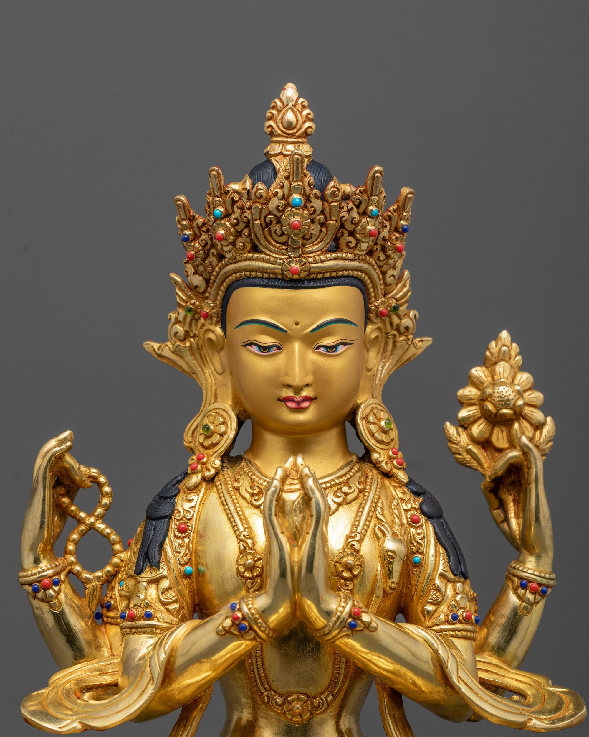 Close-up of Avalokiteshvara Chenrezig’s face with polished 24k gold finish