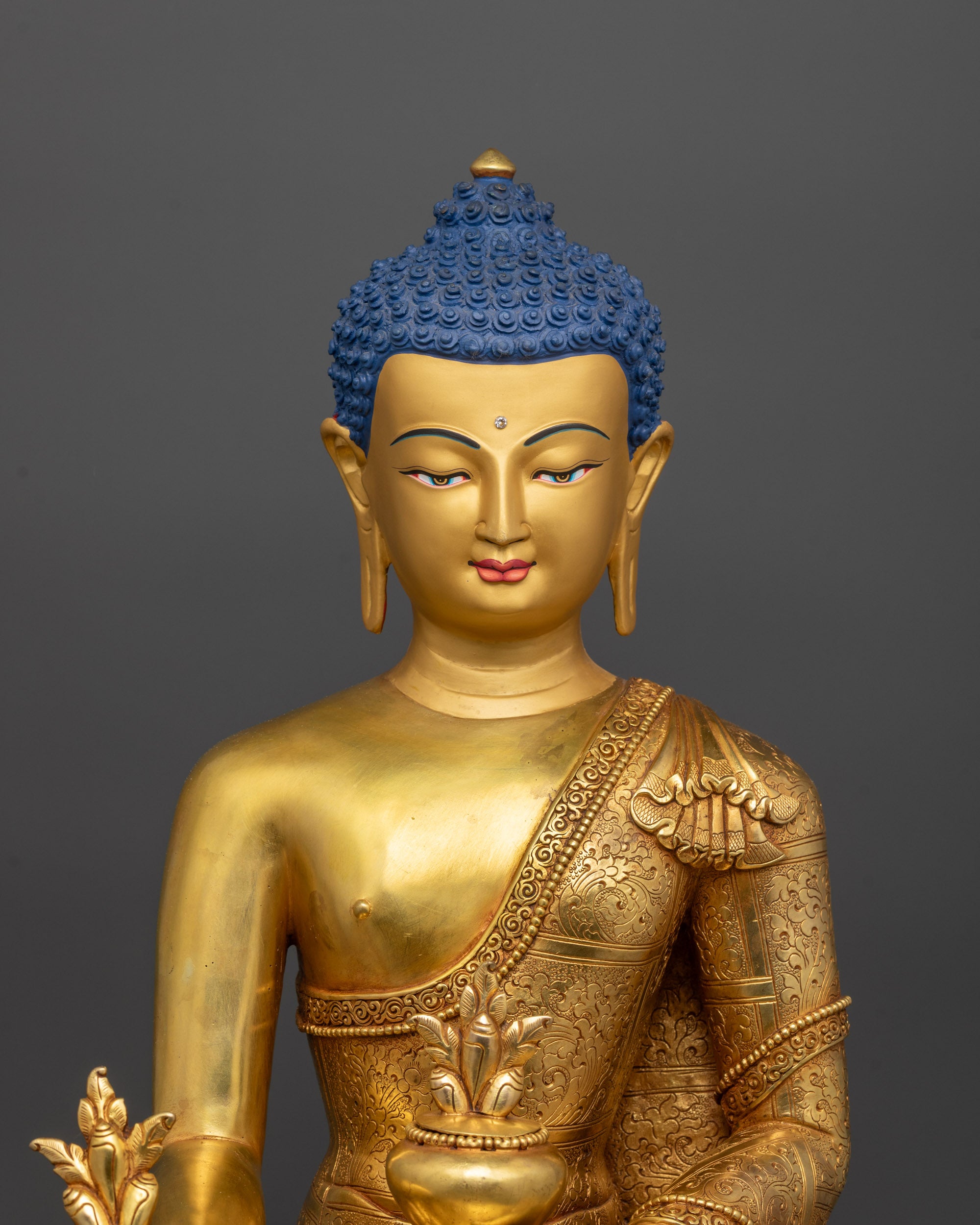 Close-up of Bhaisajyaguru Buddha holding arura fruit bowl and Terminalia chebula stem