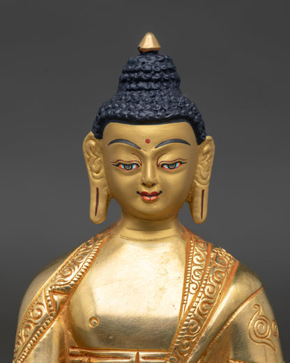 Close-up of Bhaisajyaguru statue showing 24k gold-painted face and intricate copper details