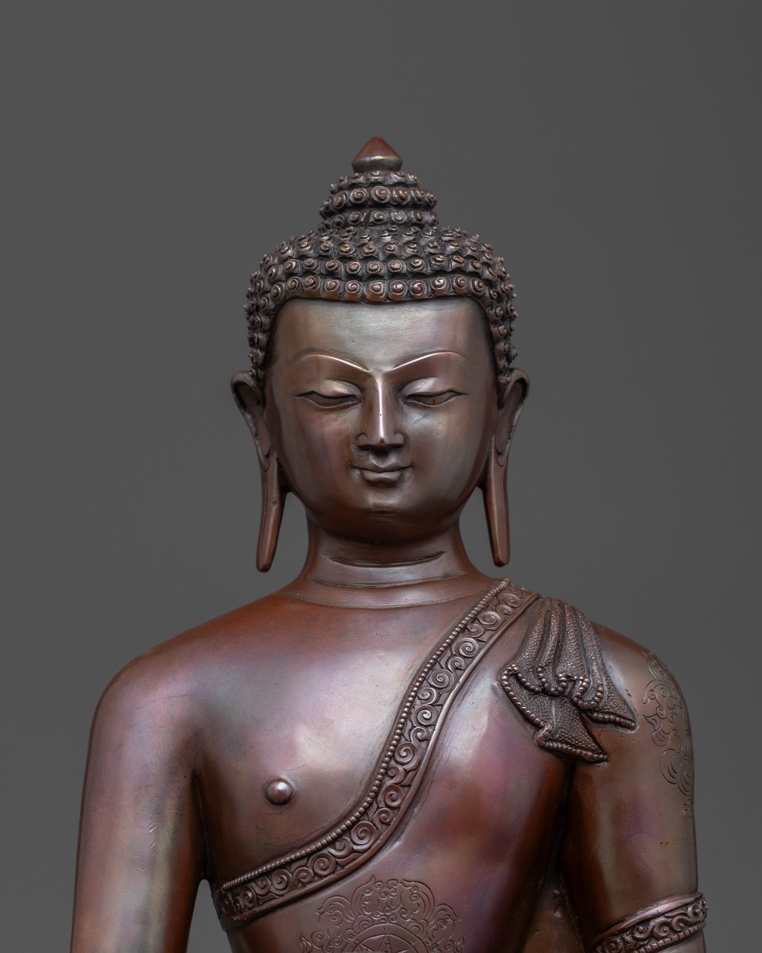 Close-up of Bhumisparsha Mudra and intricate copper craftsmanship
