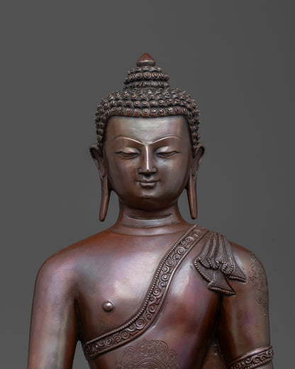Close-up of Bhumisparsha Mudra and intricate copper craftsmanship