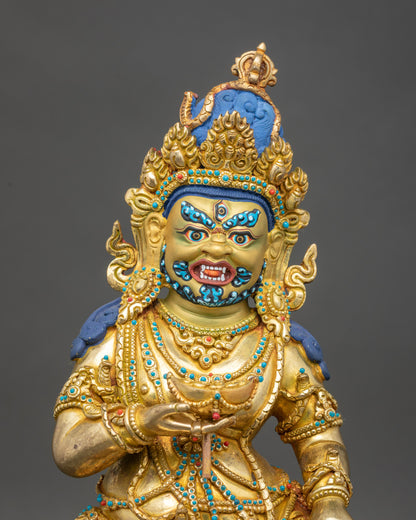 Close-up of Black Dzambhala sculpture showing intricate gold and copper details