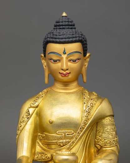Close-up of Buddha Shakyamuni Statue showing detailed robes and gold-painted face
