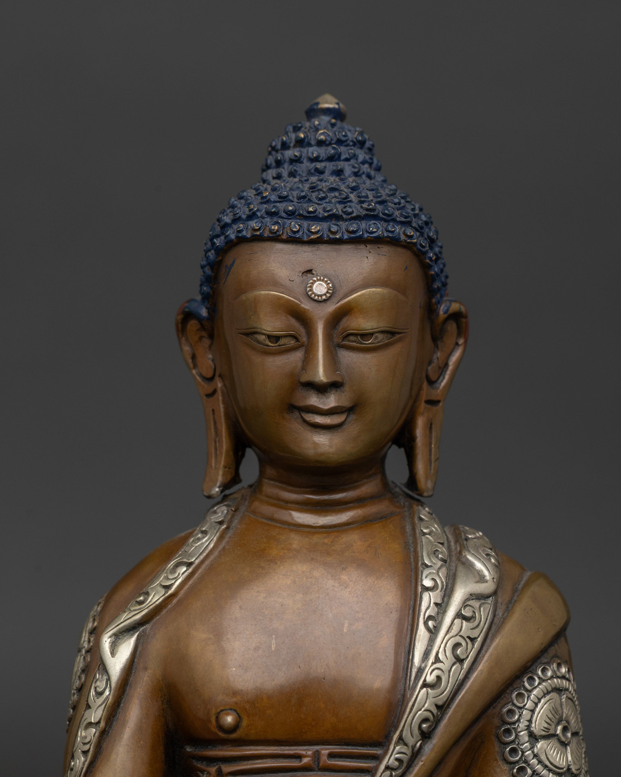 Close-up of Buddha Shakyamuni face, Newari artisan craftsmanship, lotus seat detail