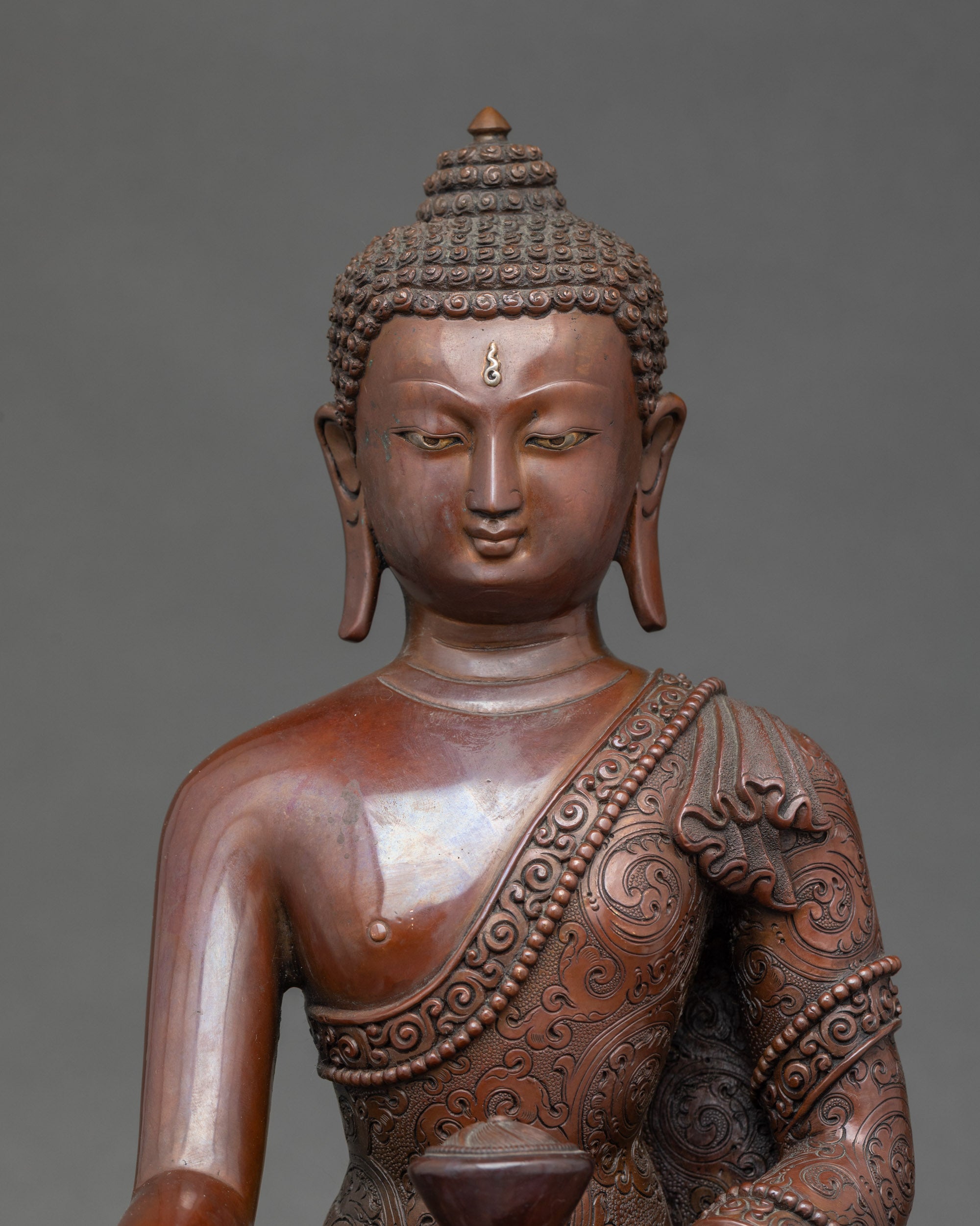 Close-up of Buddha Shakyamuni meditation sculpture showing detailed oxidized features