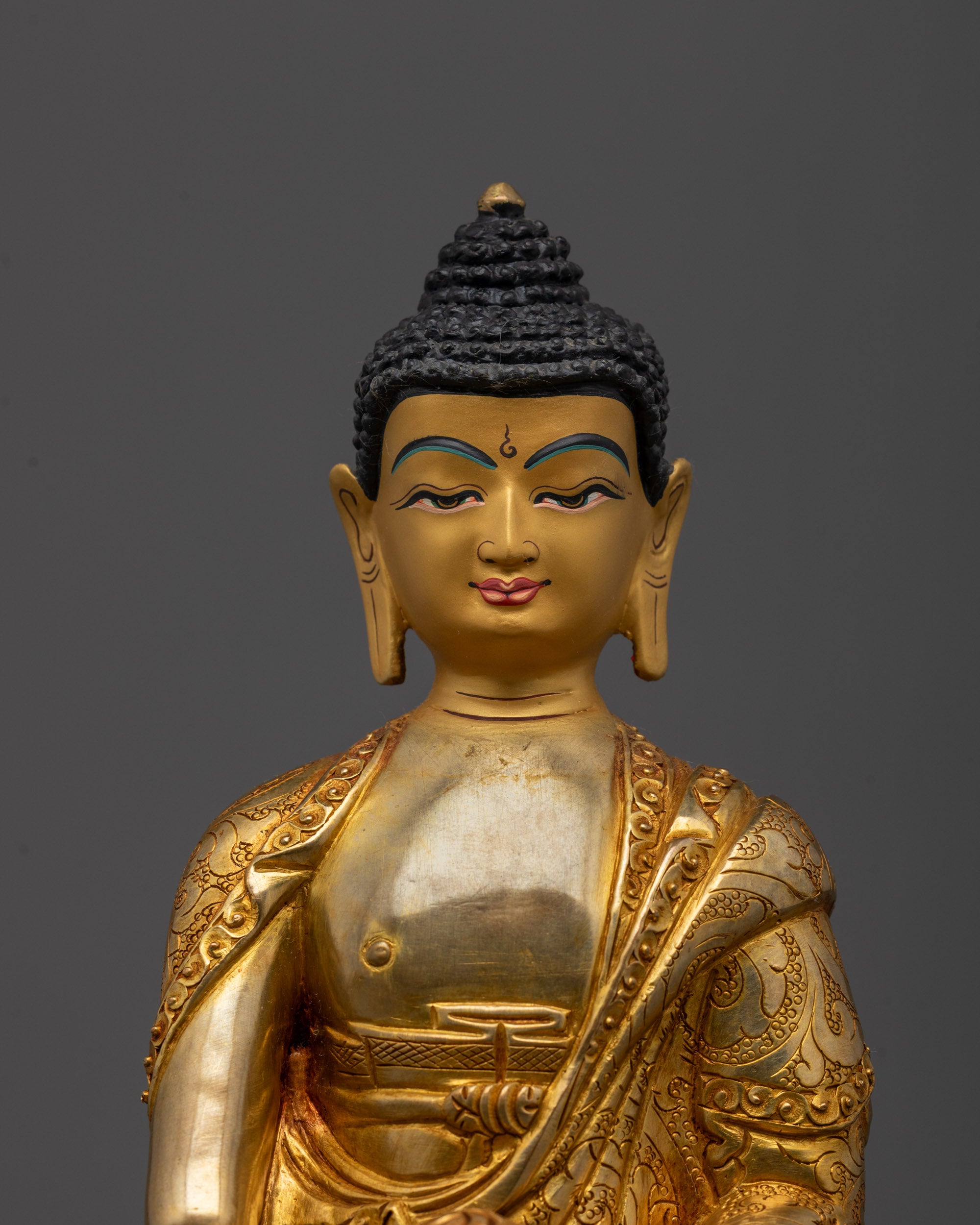 Close-up of Buddha Shakyamuni’s peaceful face and hands highlighting intricate craftsmanship