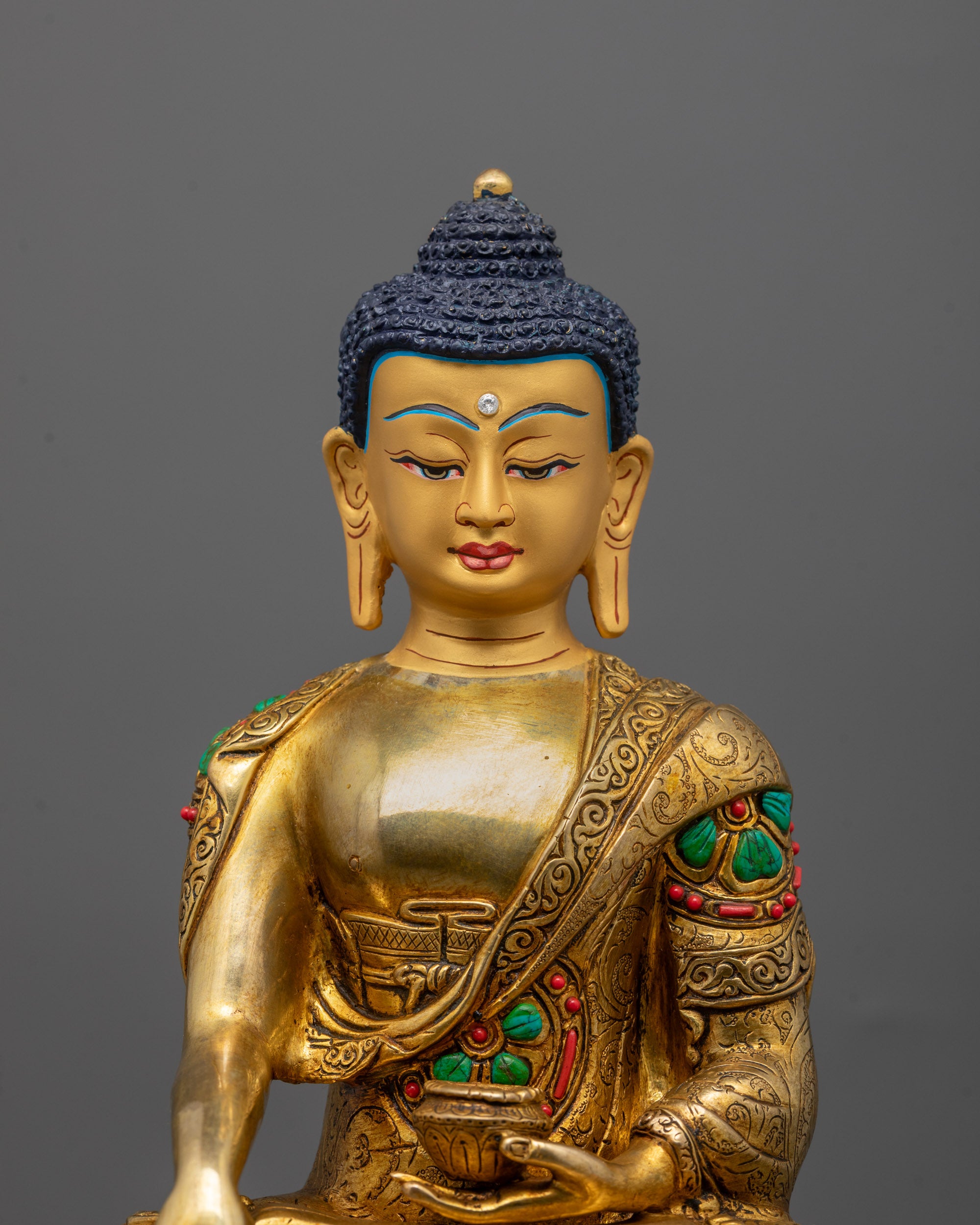 Close-up of Buddha Shakyamuni’s serene face gilded in 24k gold showcasing