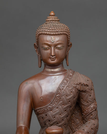 Close-up of Buddha Shakyamuni statue showing serene face and monk’s bowl details