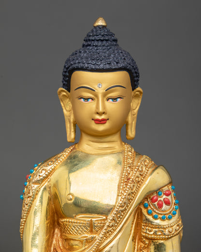 Close-up of Buddha face, gold-painted features, semi-precious stone embellishments