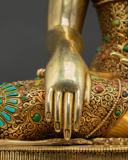 close-up-of-buddha-statues-hand-resting-on-turquoise-inlaid-lotus-base