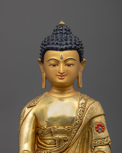 Close-up of Buddha statue’s radiant gold face and semi-precious stone decorations
