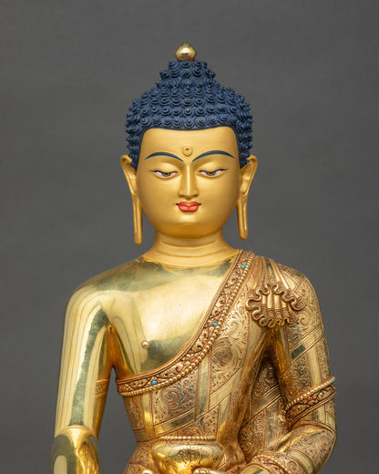 Close-up of Buddha statue showing intricate hand mudra and gold detailing