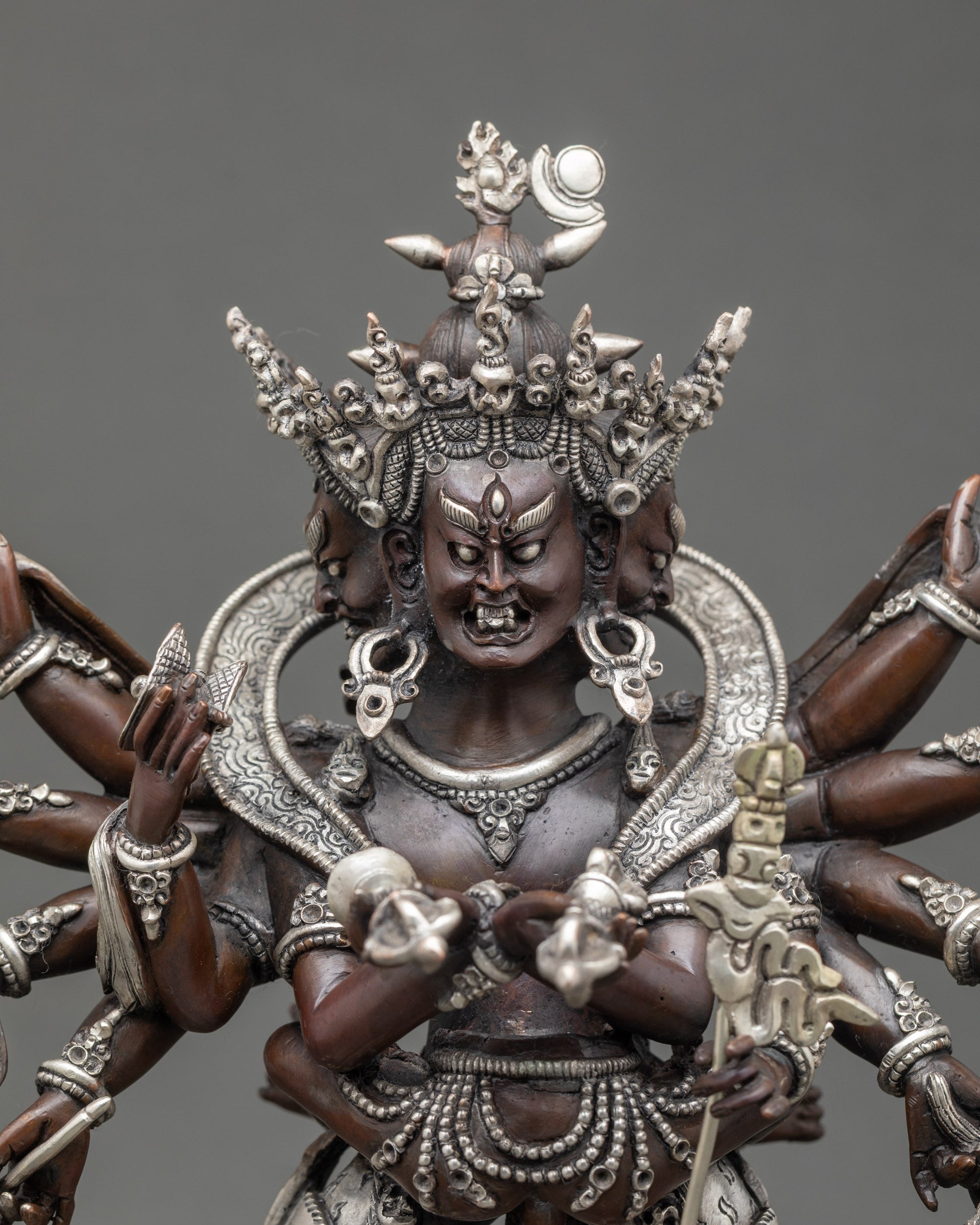Close-up of Chakrasamvara with four wrathful faces and twelve ritual arms, silver details