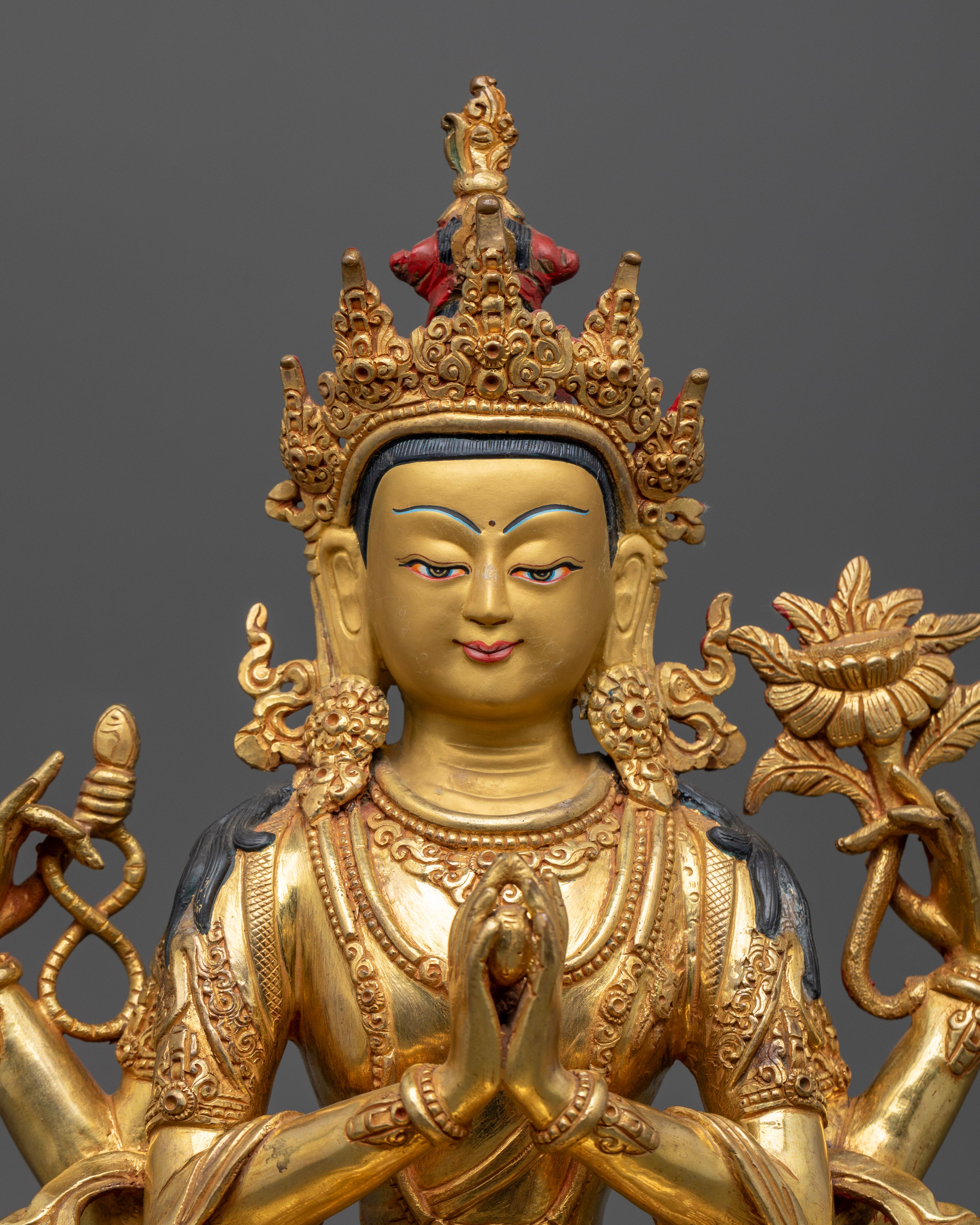 Close-up of Chenrezig Avalokiteshvara statue showing gold gilding and serene compassionate face