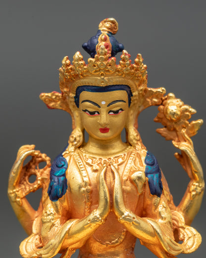 Close-up of Chenrezig Bodhisattva face showing serene expression and gold detailing