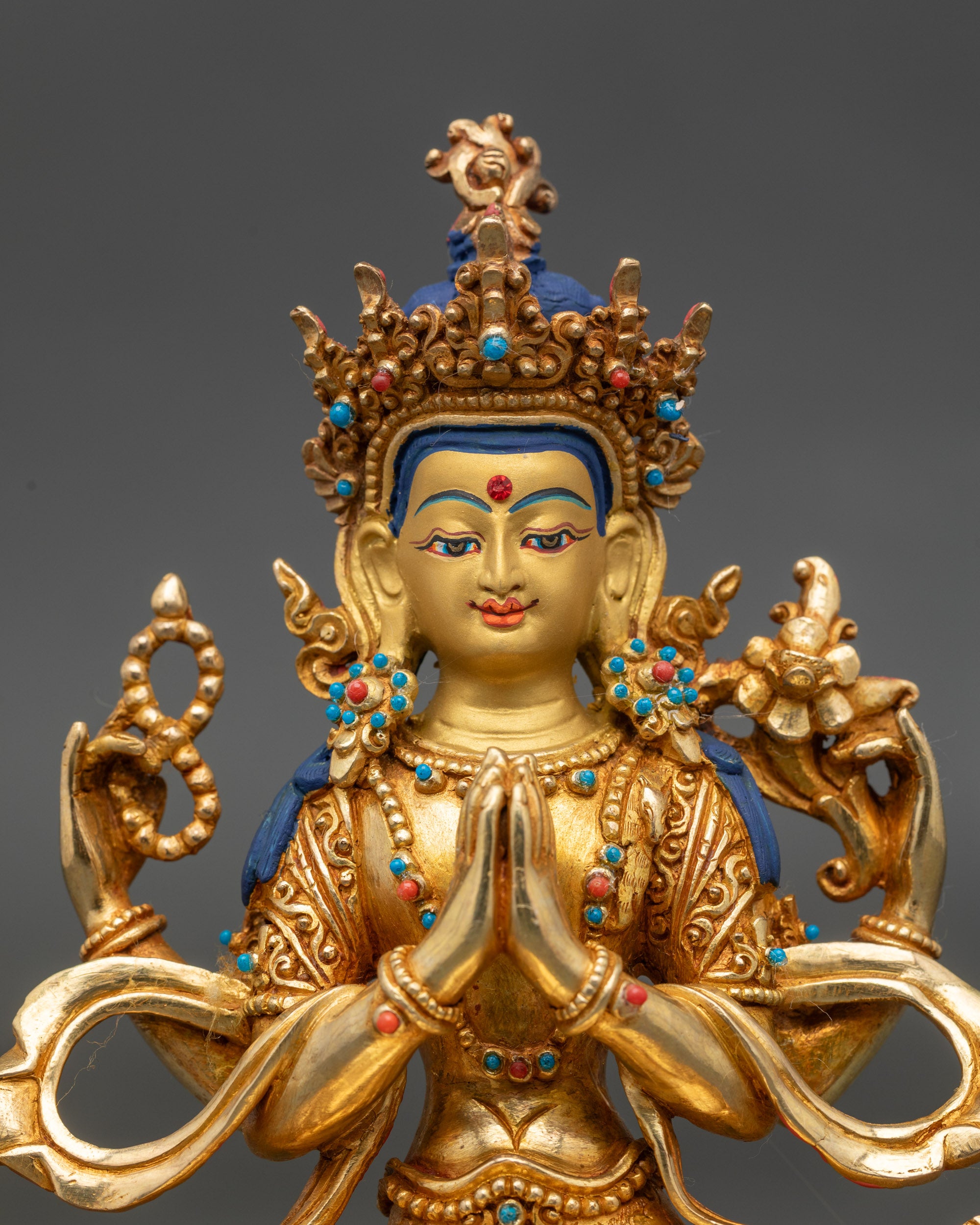 Close-up of Chenrezig Bodhisattva face with radiant gold fire-gilding details